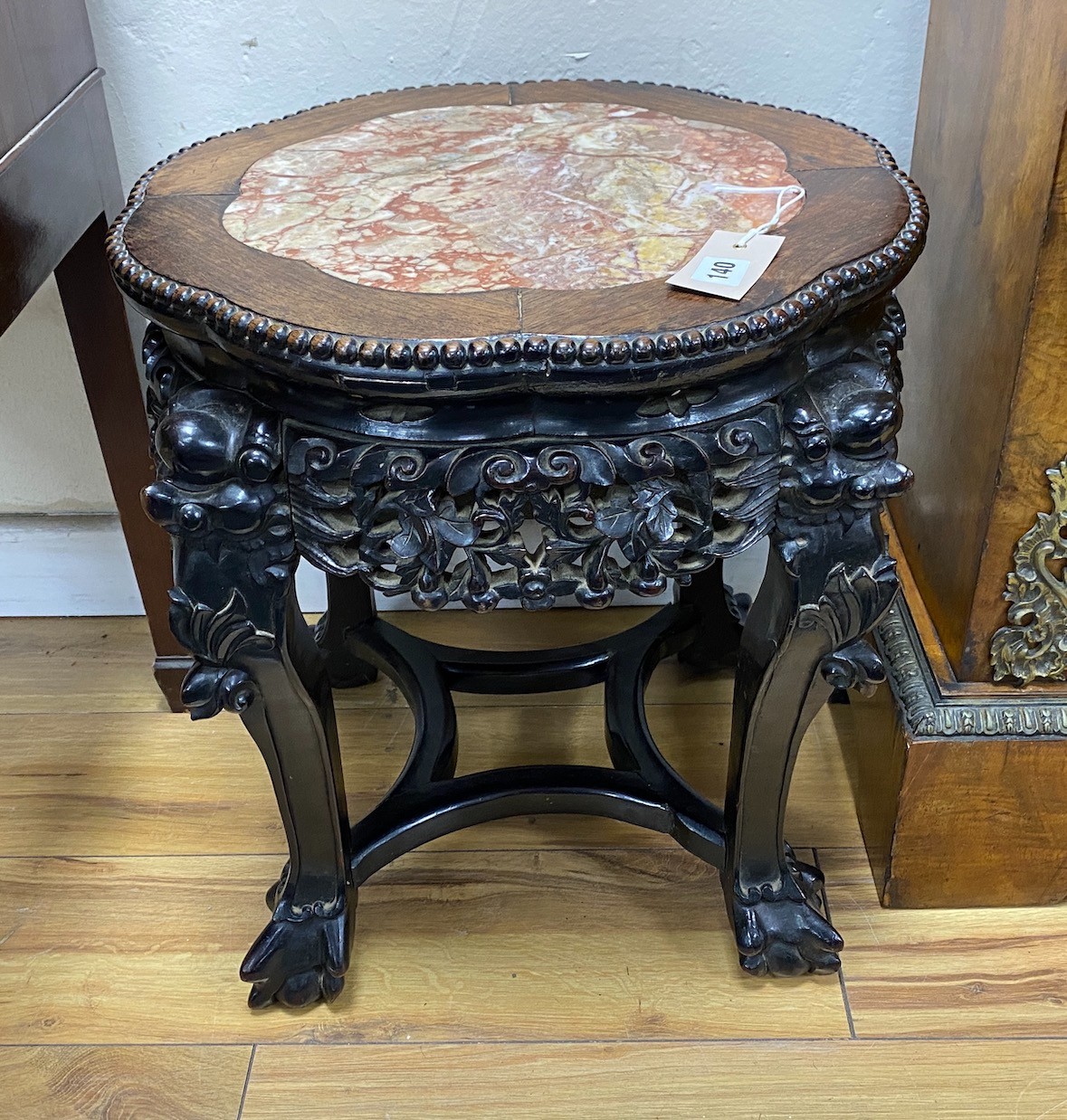 A pair of Chinese Hongmu circular marble topped jardiniere stands, diameter 44cm, height 45cm